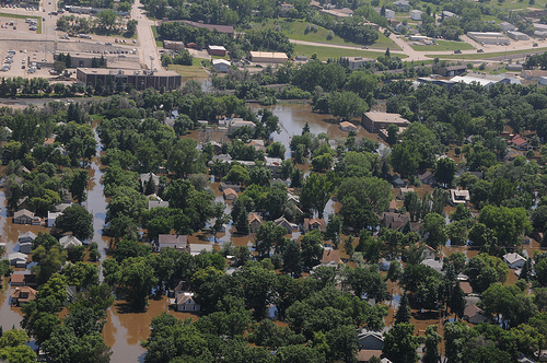 The Souris River, continues to flow over Minot, N.D. flood levees June 23, as the water begins to inundate residential neighborhoods. (DoD photo by Senior Master Sgt. David H. Lipp)