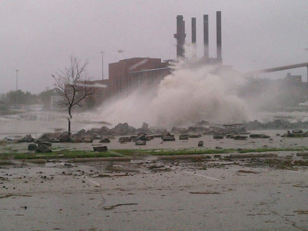 NewsChannel5 photo of large waves crashing against shore in foreground, smokestacks in background