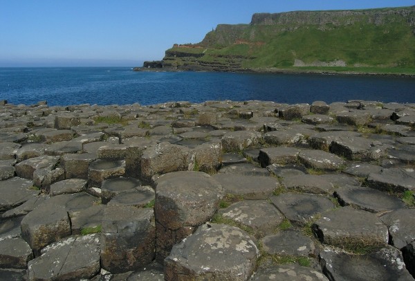 Giant's Causeway in the foreground, cliffs of more lava punctuated by a red laterite horizon beyond.  Photo: Chris Rowan, 2013
