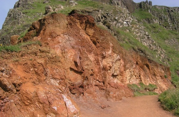 A close-up of the laterite horizon in the cliffs above the Giant's causeway, formed by intense weathering of the top of a lava flow before the next eruption.  Photo: Chris Rowan, 2013