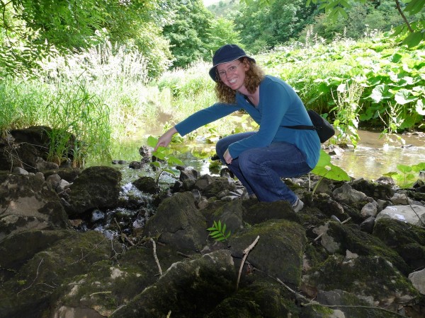 Anne poses next to a sinkhole. Photo: Chris Rowan, 2014.